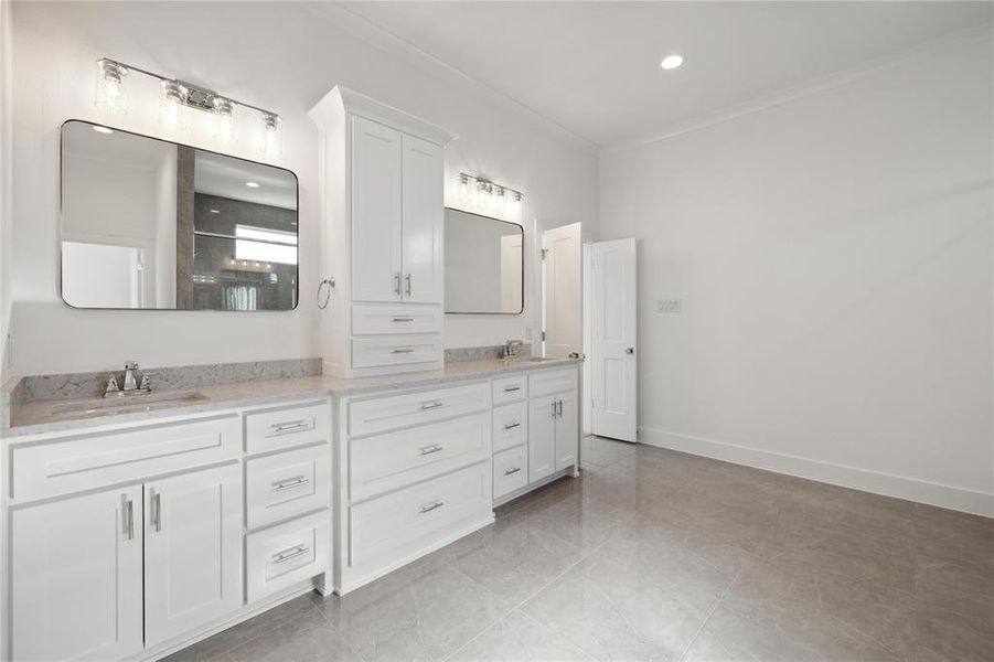 Bathroom featuring walk in shower, vanity, and crown molding