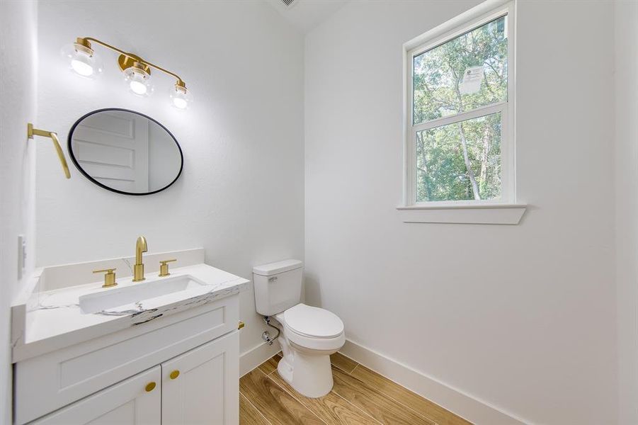 This charming half bath is a hidden gem, offering a blend of modern elegance and practicality. With its sleek fixtures and thoughtfully chosen finishes, it’s the perfect space for guests or a quick refresh.