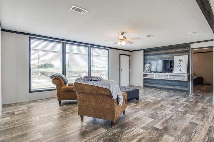 Bedroom featuring ceiling fan, ornamental molding, and hardwood / wood-style floors