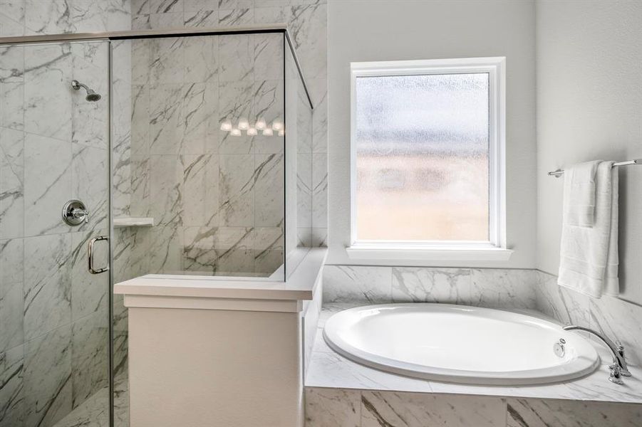 Elevate your relaxation game with this pristine, soaking tub and shower.