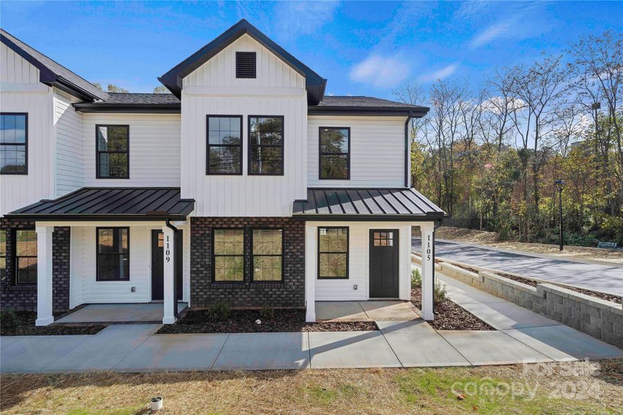 Exterior with lots of character with brick & black windows, soffit, aluminum roof accents, etc...