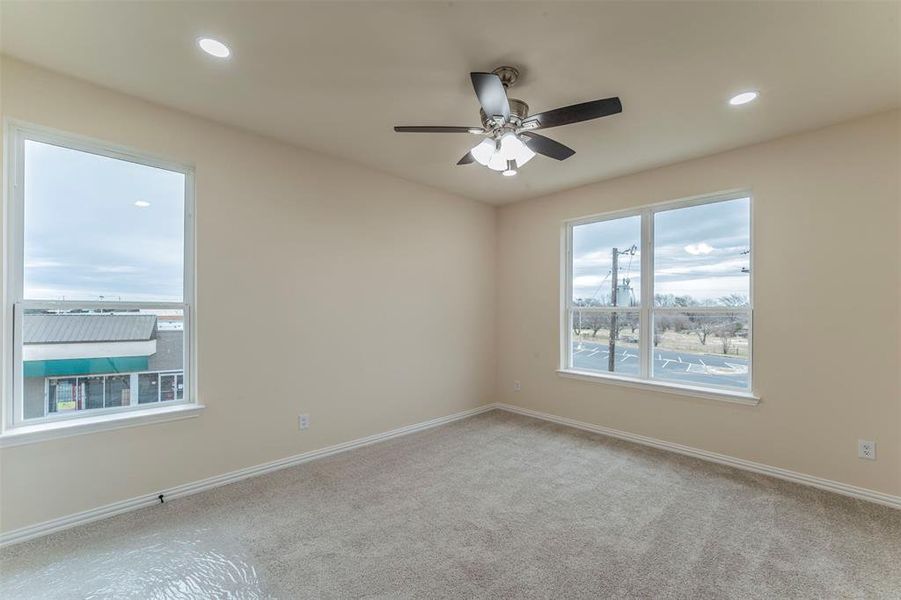 Unfurnished room with ceiling fan and carpet floors