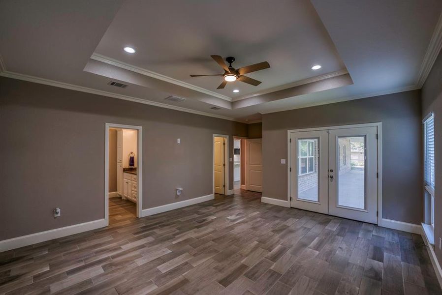 Views of Primary bathroom to the left and the entrance to walkin closet as well as  private access to screened porch