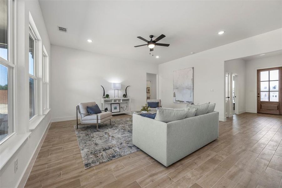 Living room featuring ceiling fan and light wood-type flooring