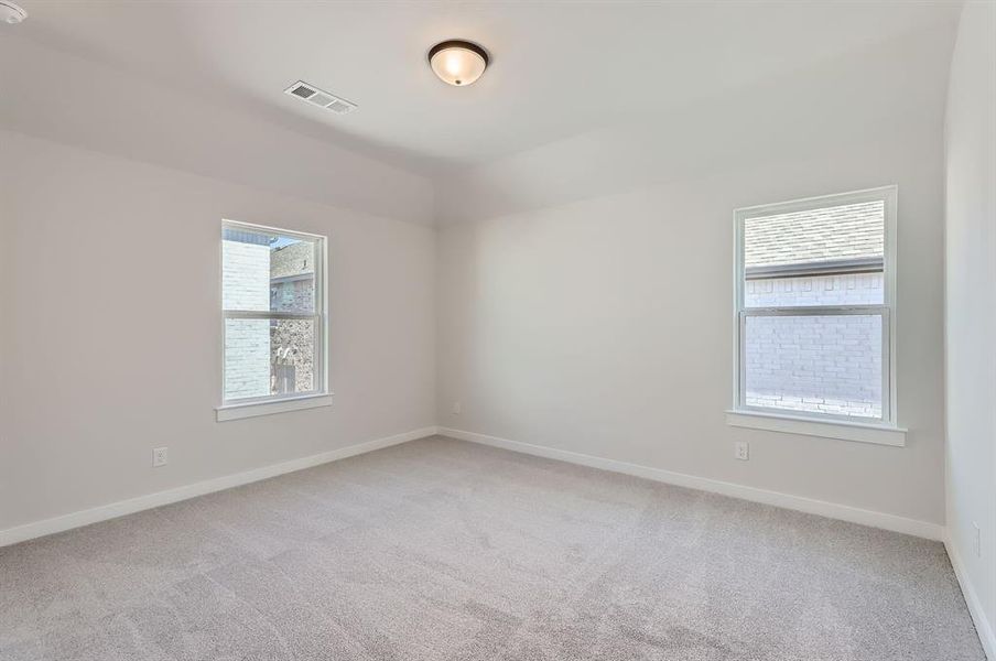 Carpeted empty room featuring plenty of natural light