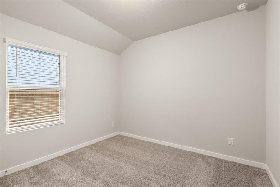 Another view of the Striking Secondary bedroom featuring plush carpet, oversized windows and walk-in closet for added storage.