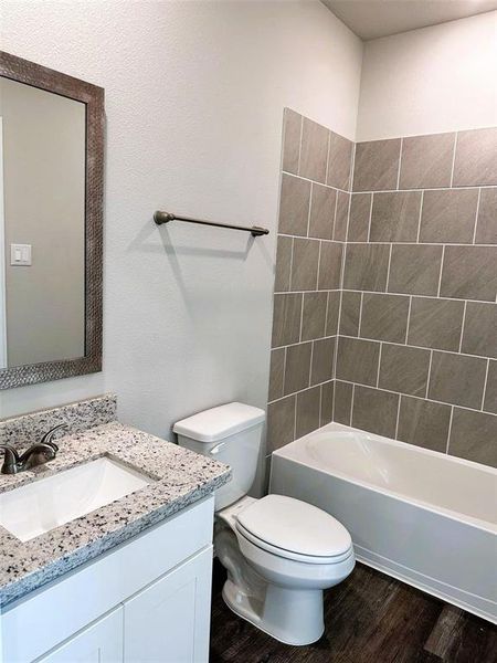 Bath 2 features a stylish framed mirror, granite counters, ceramic tile bath tub walls.(sample photo)