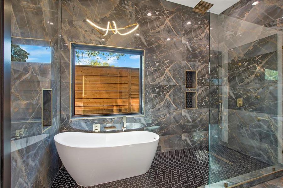 Bathroom featuring tile walls, tile patterned floors, and plus walk in shower