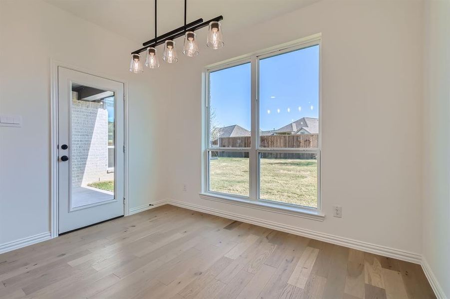 Unfurnished dining area with light hardwood / wood-style floors