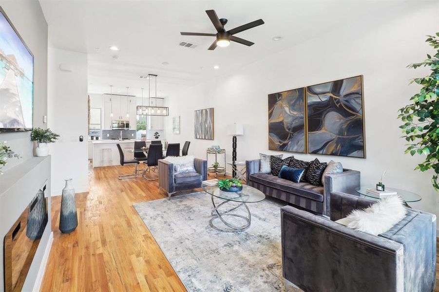 Living room featuring light hardwood / wood-style floors, sink, and ceiling fan