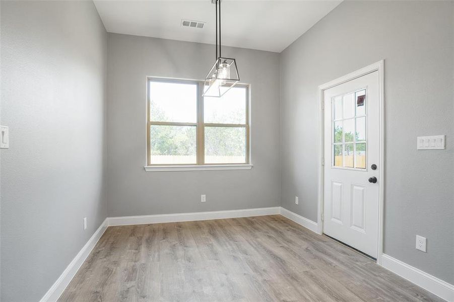 Entrance foyer featuring a chandelier and light hardwood / wood-style floors