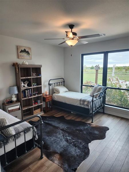 Bedroom featuring ceiling fan and hardwood / wood-style floors