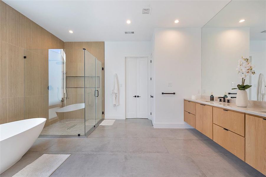 Bathroom featuring vanity, concrete floors, and independent shower and bath