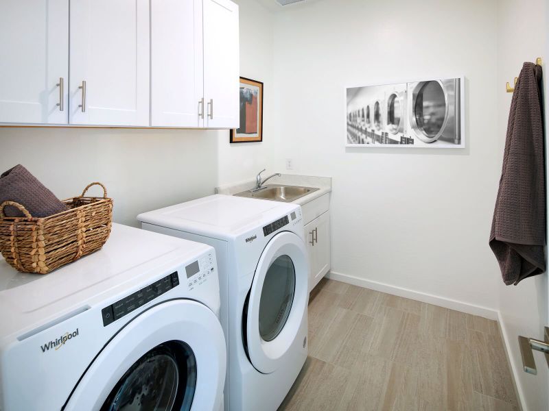 Laundry room in Jubilee Floorplan at Camino Crossing with sink - model feature only