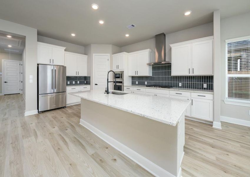 The oversized granite island is the shining star of the kitchen.