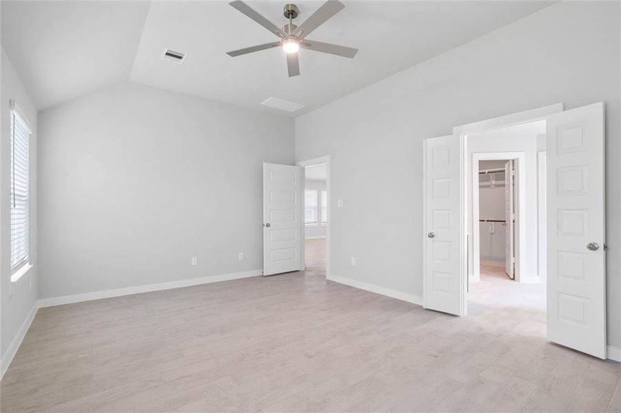 Another gorgeous view of this primary suite looking into the primary bathroom and large walk-in closet!