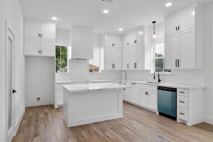 Everything you need to make your culinary dreams come true! An island with additional seating, large undermount sink, custom cabinetry and a walk-in pantry.