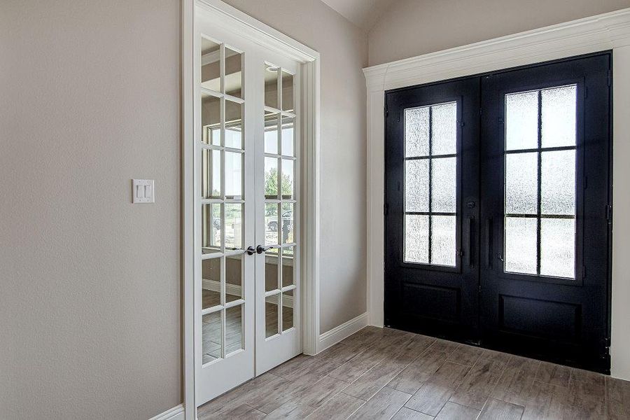 Doorway to outside with wood-type flooring and french doors