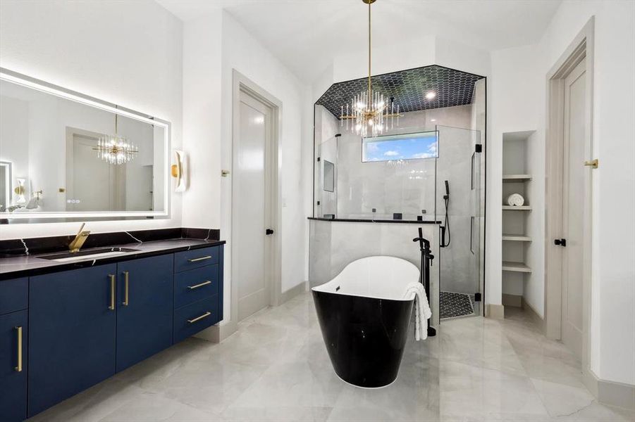 Bathroom featuring separate shower and tub, tile patterned floors, vanity, and an inviting chandelier