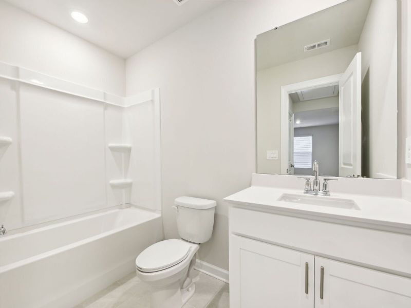 The secondary bathroom offers space for guests to get ready.