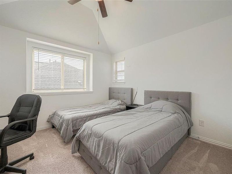 This versatile bedroom features two twin beds, perfect for roommates, siblings, or guests. The neutral color scheme and clean lines create a calming and inviting atmosphere.