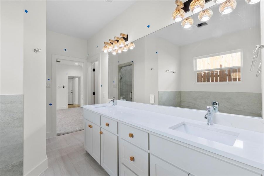 Bathroom featuring vanity and a shower with shower door