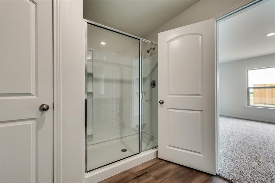 Bathroom with walk in shower and hardwood / wood-style floors