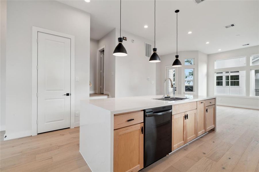 A sleek modern kitchen gives a transitional feel to a stunning home with design.