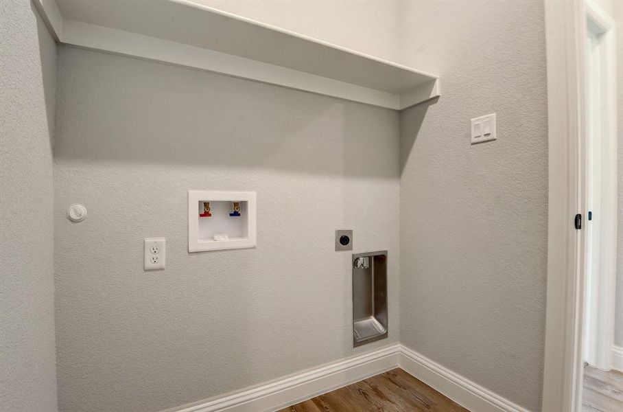 Washroom featuring hookup for an electric dryer, washer hookup, and hardwood / wood-style floors