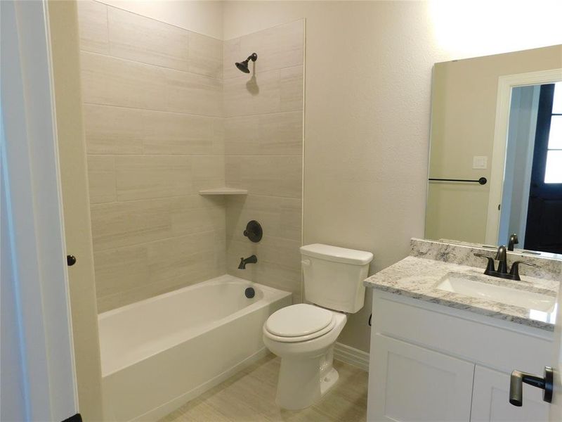 Hall bathroom with tub & shower combo & full size sink with granite countertop