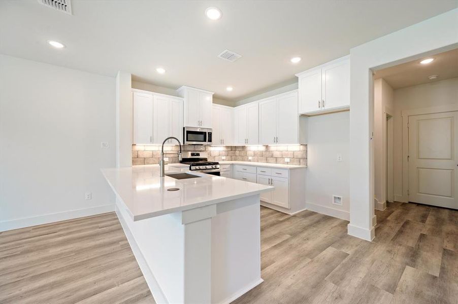 The kitchen offers a breakfast bar that does double duty as a homework station or a place to grab a quick bite!