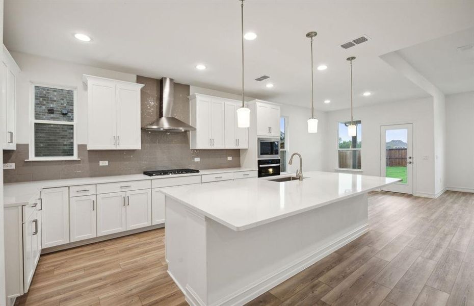 Airy kitchen with oversized island *real home pictured