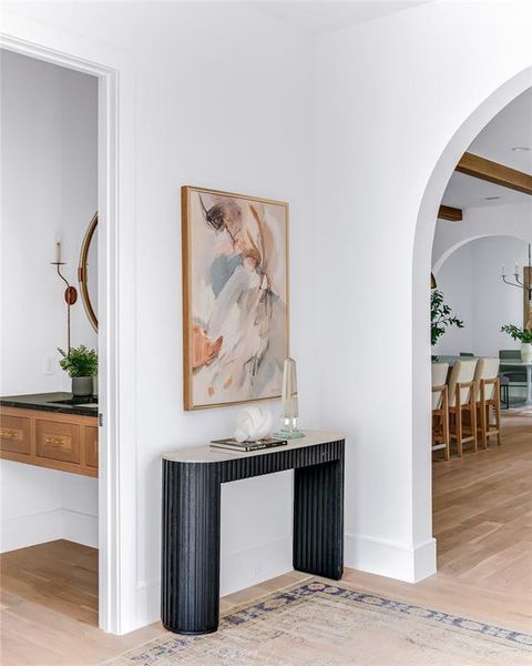 Corridor with hardwood / wood-style floors