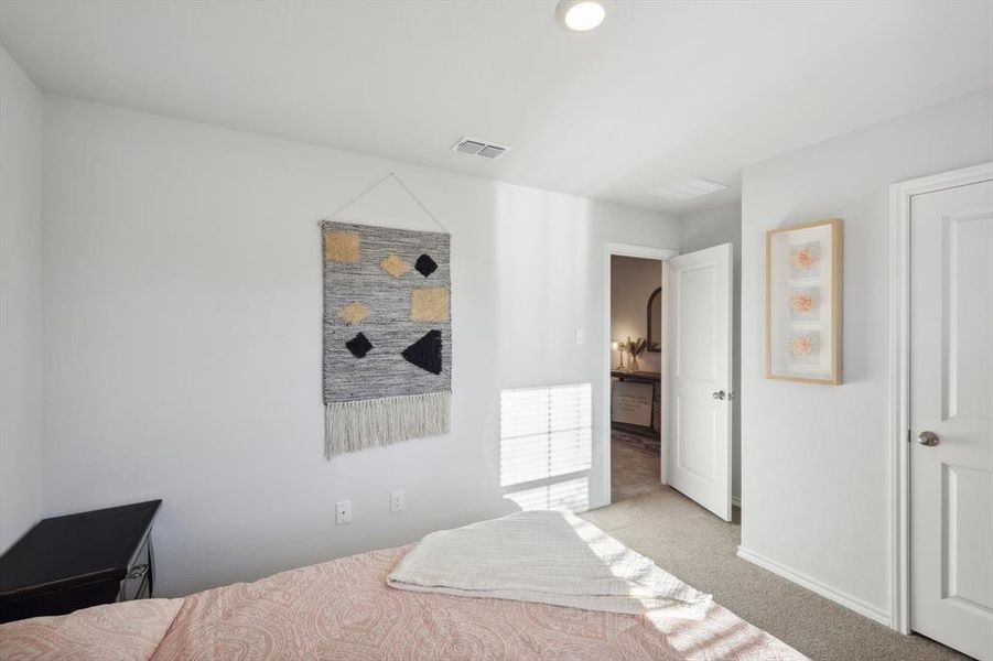 Bedroom featuring light carpet