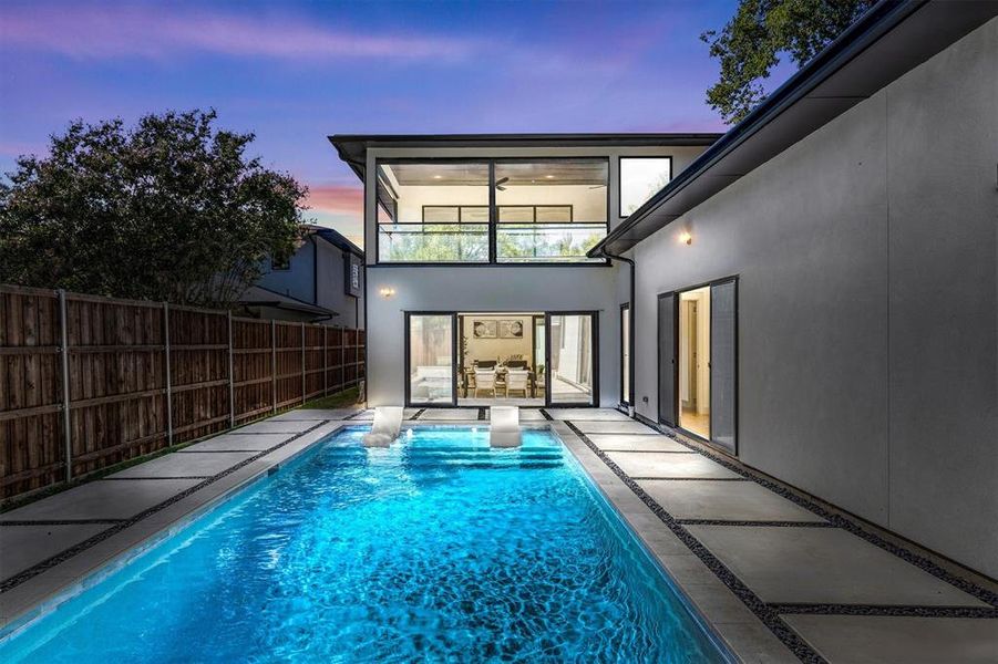 Pool at dusk with a patio