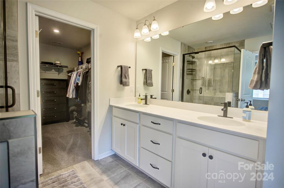 Primary bath with adjacent walk in closet, dual vanity