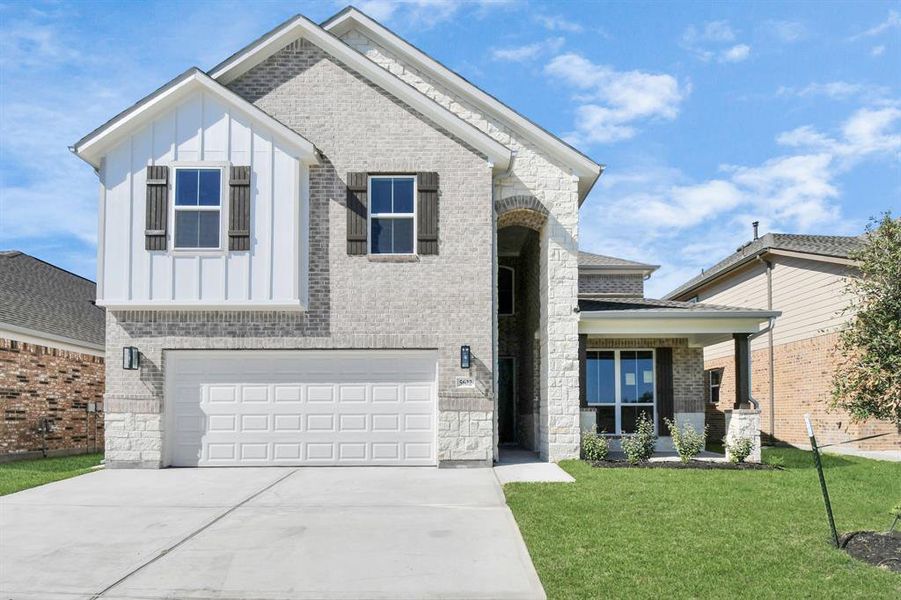 Home showcases all brick premium elevation, lush landscaping, a convenient 2-car garage paired with a spacious driveway, providing ample room for parking.