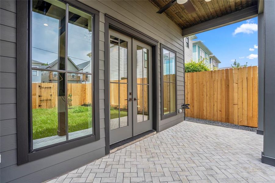 Custom herringbone tiles on your backyard covered patio. Notice this patio has a gas line for a summer kitchen or grill.