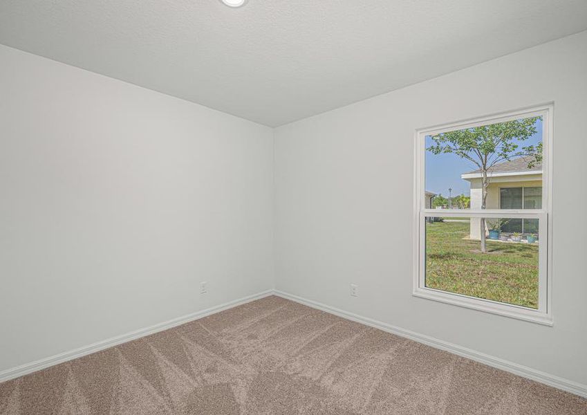 The guest bedroom is spacious with natural light