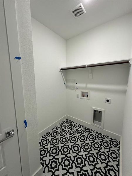 Washroom with tile floors, washer hookup, and hookup for an electric dryer