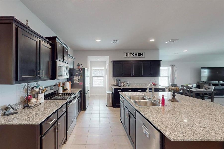 Kitchen featuring stainless steel appliances, sink, a wealth of natural light, and light tile floors