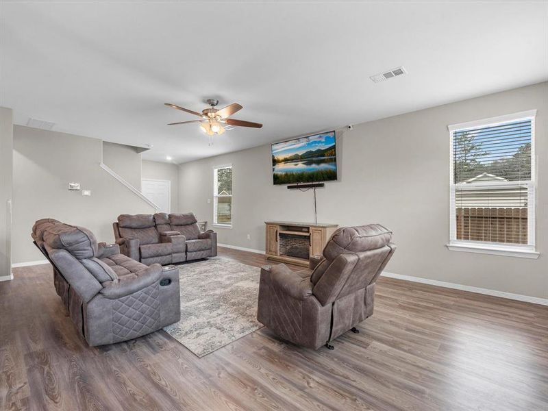 Your family room has ample space to entertain family and friends. This space features beautiful floors, fresh paint, ceiling fan with lighting, and high ceilings.