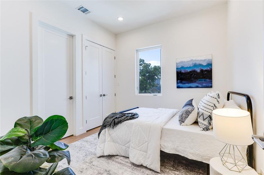 Bedroom with hardwood / wood-style flooring