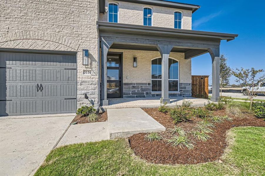 View of front of home with covered porch and a garage