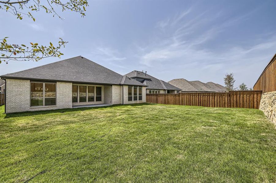 Rear view of house with a lawn