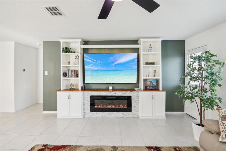 Living room with ceiling fan and light tile patterned floors