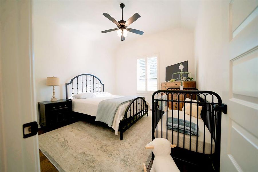 Bedroom featuring wood-type flooring and ceiling fan