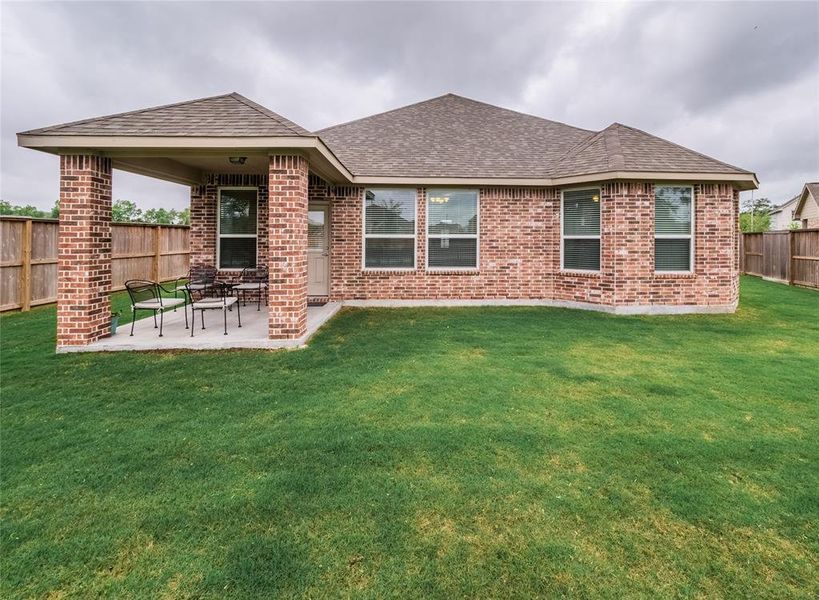 this shows the rear of the home, you have the covered patio that is great for sitting outdoors