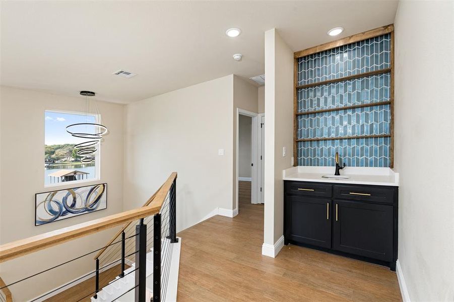 Unfurnished living room with ceiling fan, light wood-type flooring, and ornamental molding