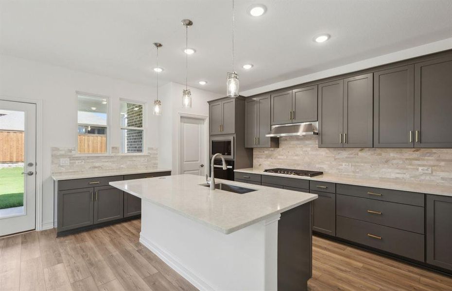 Bright kitchen with ample cabinet space and oversized island *real home pictured